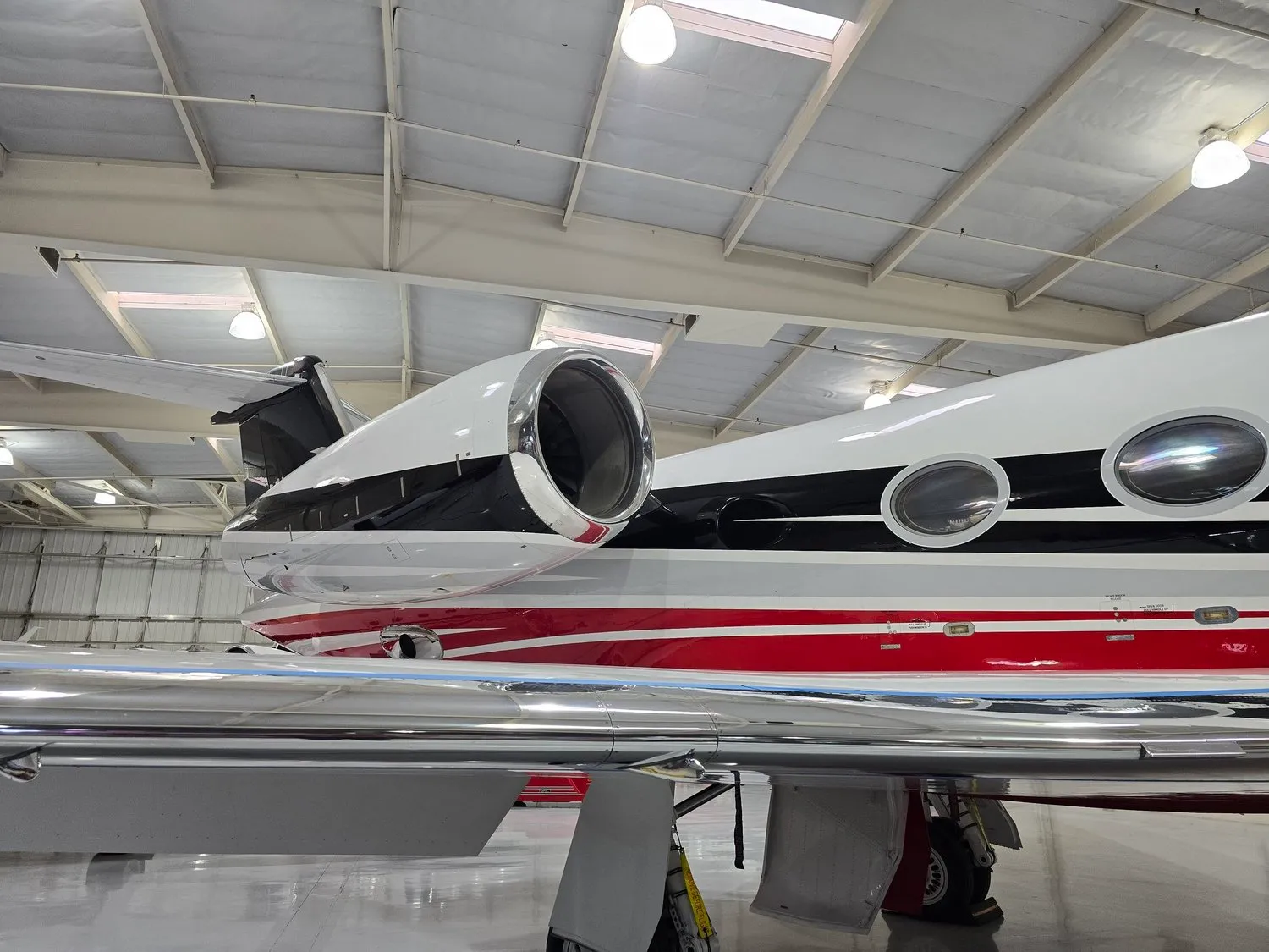 Engine and rear fuselage of a private jet protected by aviation-grade ceramic coating in a Las Vegas hangar.