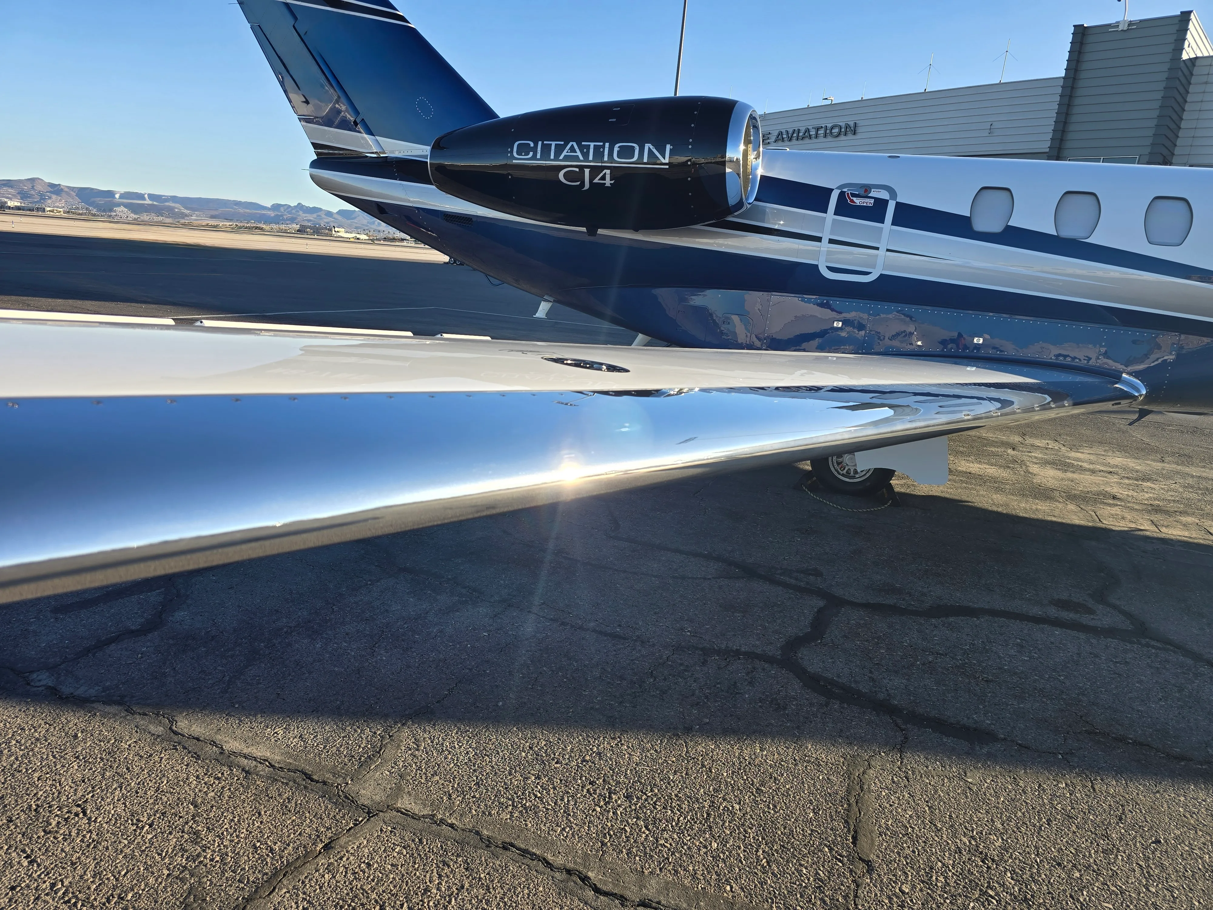 Mirror-finish polished fuselage of a Cessna Citation after professional exterior detailing.