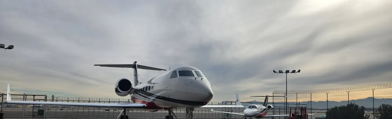 Two private jets on a Las Vegas ramp at dusk, detailed by Crystal Skies.