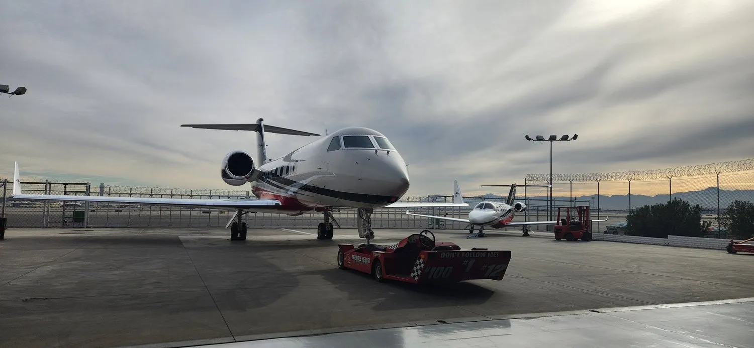 Two private jets parked on a Las Vegas tarmac at sunrise after exterior detailing by Crystal Skies.