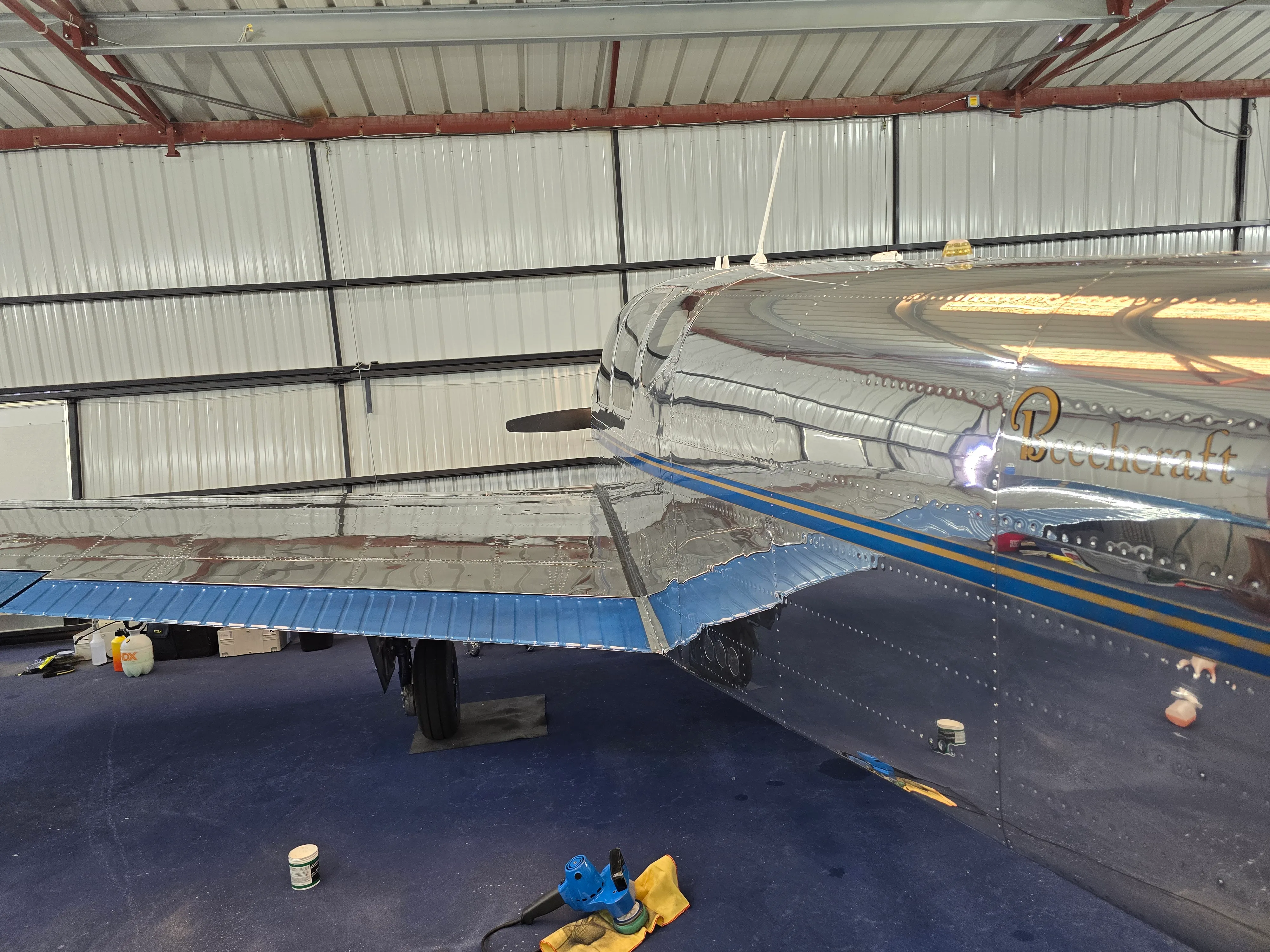 Aircraft being prepped in hangar with equipment and tow-out setup for professional trip clean service.