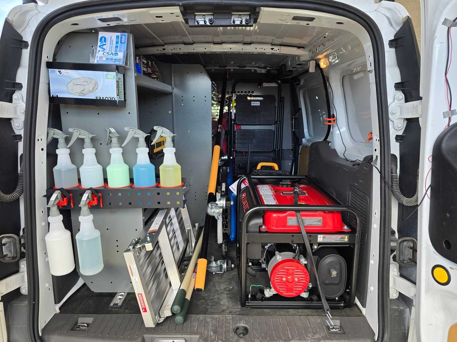 Crystal Skies service van interior with detailing supplies, generator, and tools organized for mobile work.