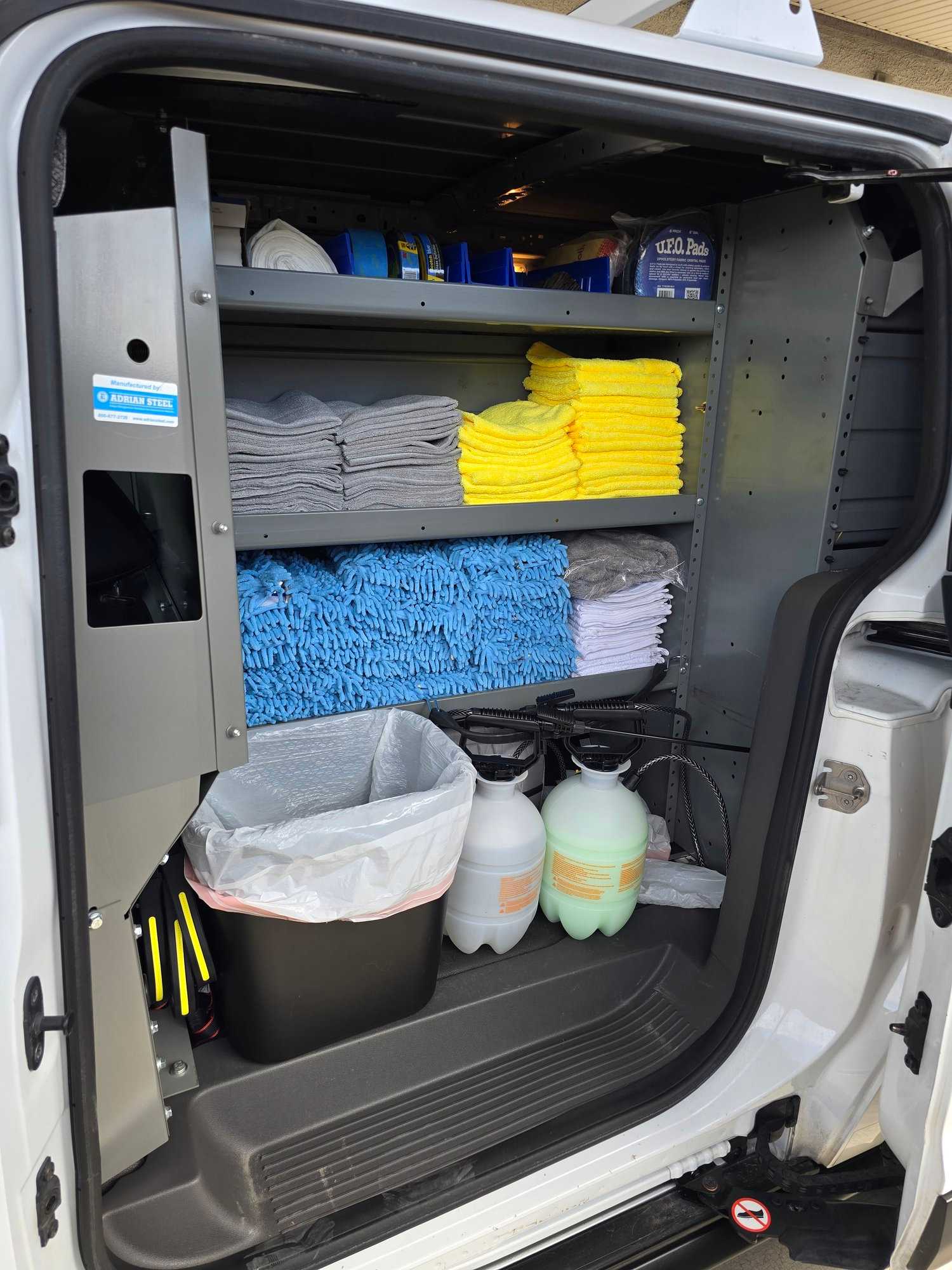 Organized stacks of microfiber towels, mitts, and aviation-safe cleaners in the Crystal Skies van.